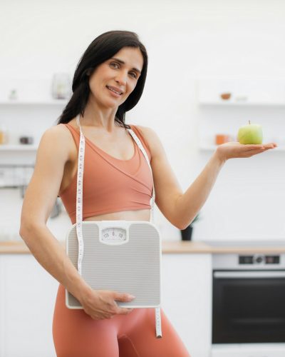 health-coach-with-measuring-tape-scales-and-apple-at-home.jpg